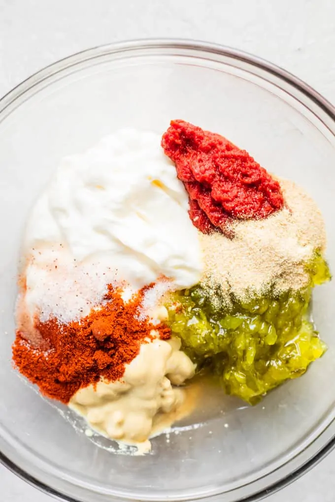 Ingredients for homemade burger sauce in a small glass bowl before mixing.