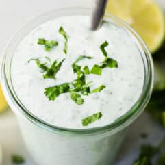 Glass jar filled with creamy Cilantro Lime Crema.