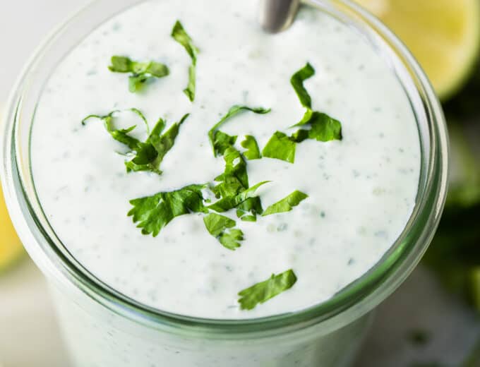 Glass jar filled with creamy Cilantro Lime Crema.