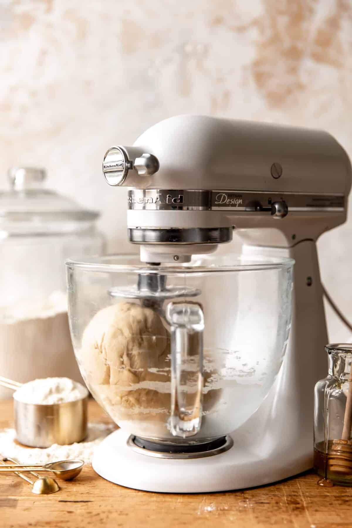 Stand mixer with dough hook kneading dough for Texas Roadhouse Rolls.