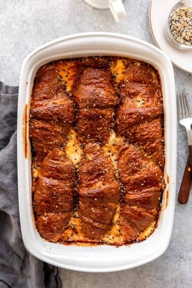 Baking dish with ham and cheese croissant breakfast casserole.
