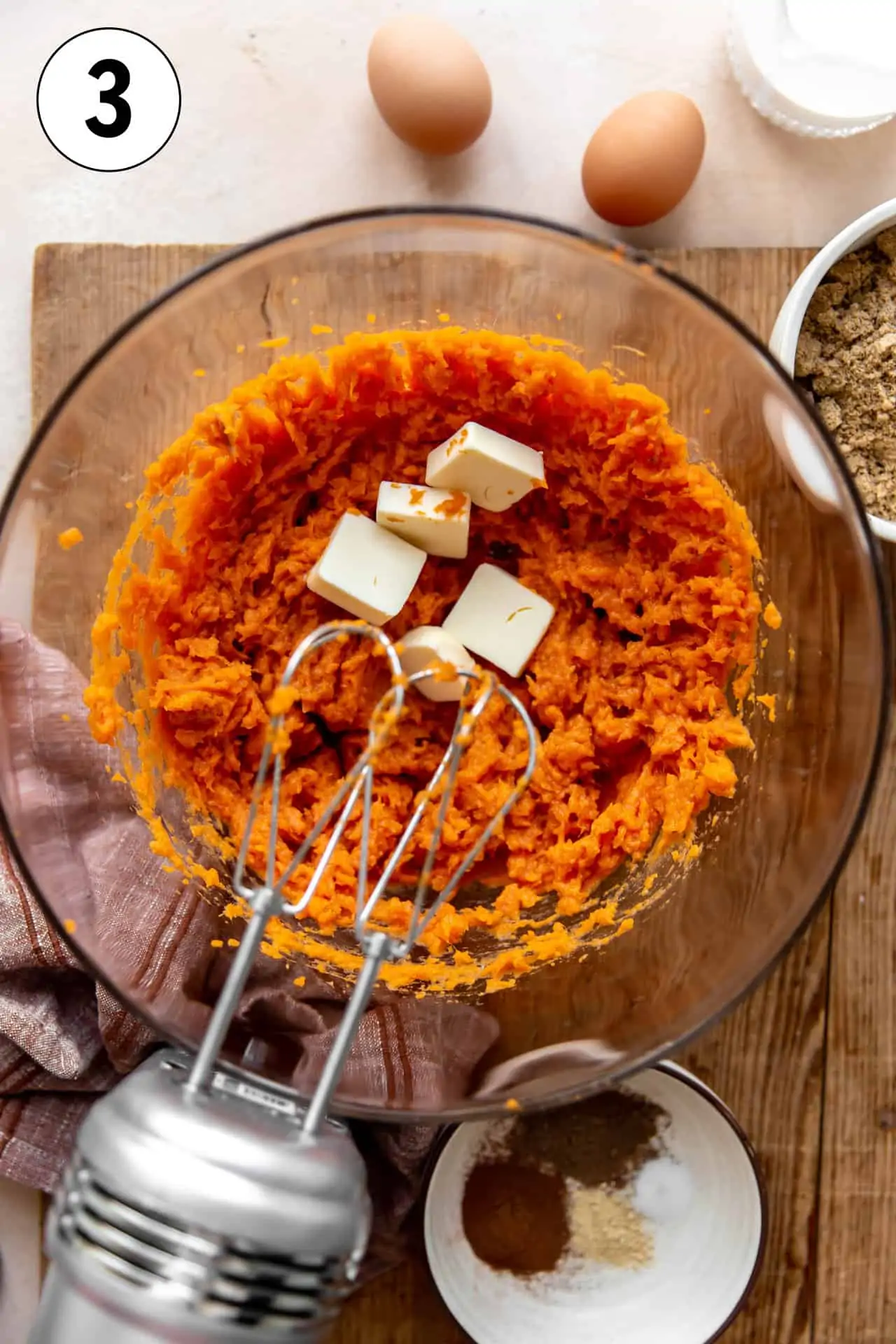 Making homemade sweet potato puree with blended sweet potato and butter.