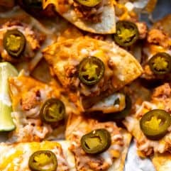 Texas Nachos made with refried beans, cheese and jalapeno on a tray to be served.