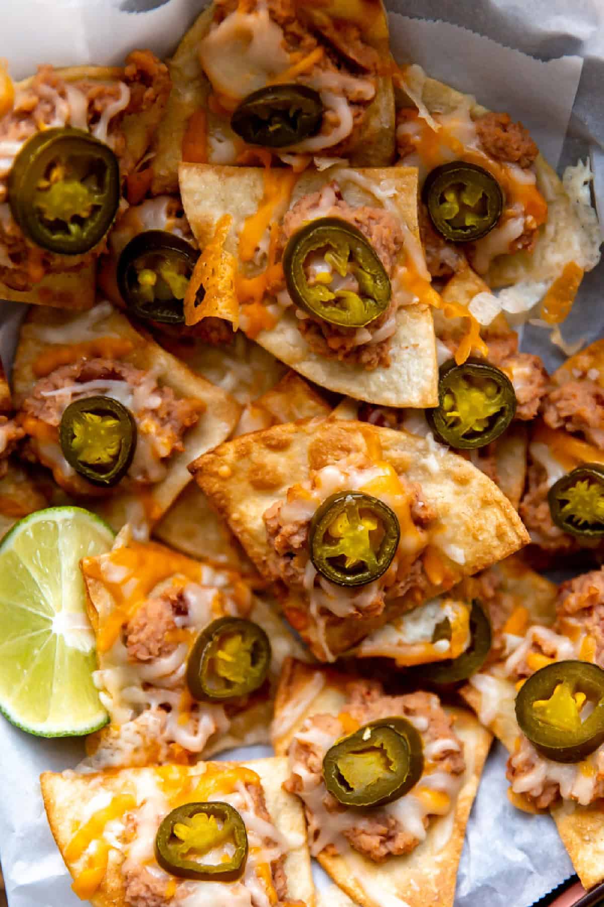 Texas nachos topped with refried beans, melted cheese, and pickled jalapeños. 