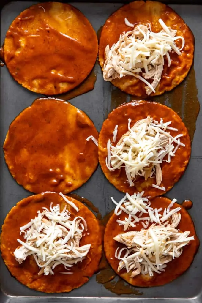 Corn tortillas smothered with enchilada sauce and topped with shredded chicken and cheese.