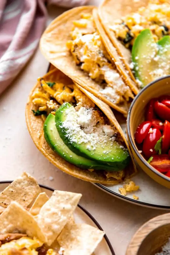 Migas served in corn tortillas with avocado and crumbled queso fresco.