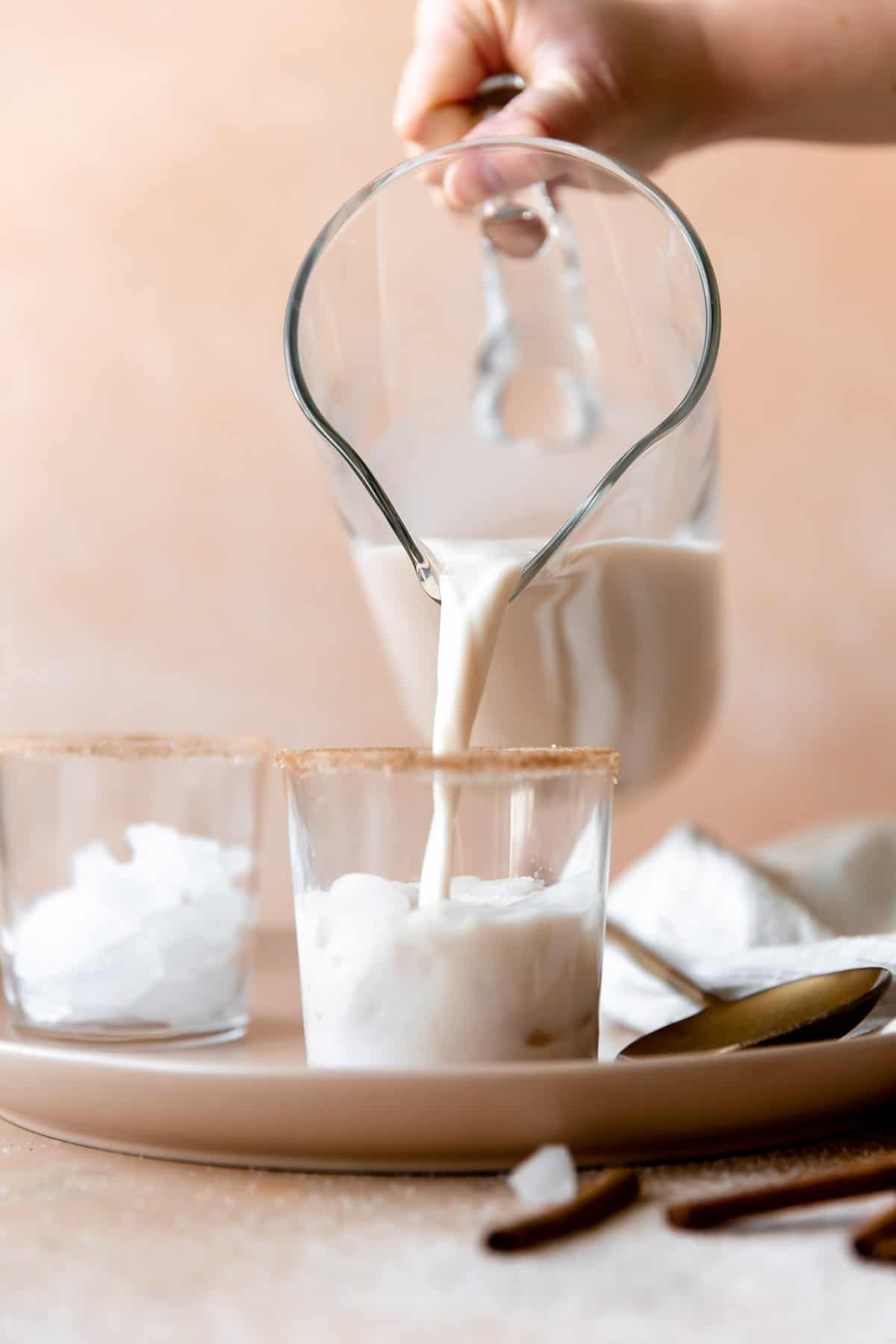 Pouring a glass of horchata.