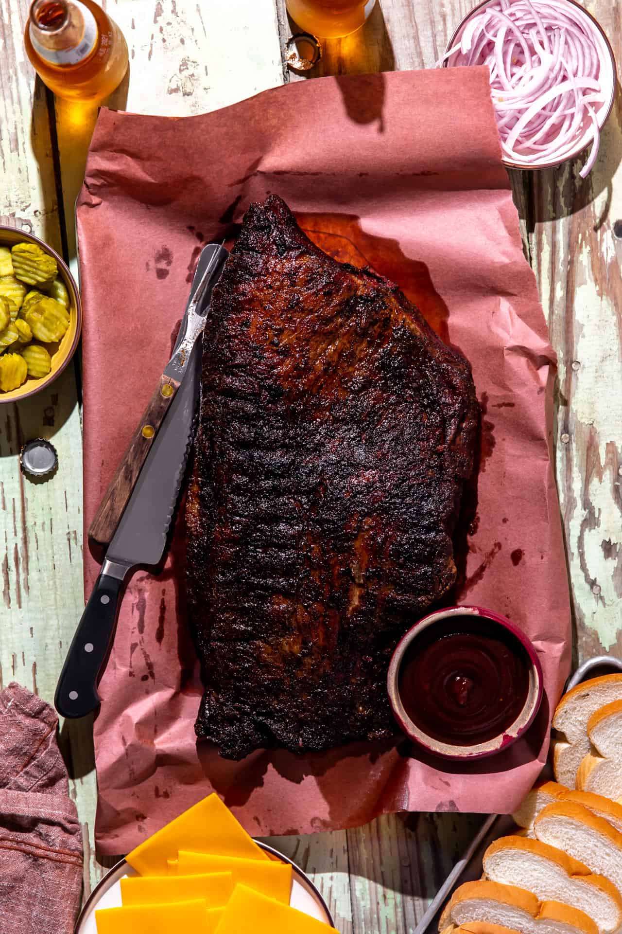 Whole brisket laying on peach paper after being smoked.
