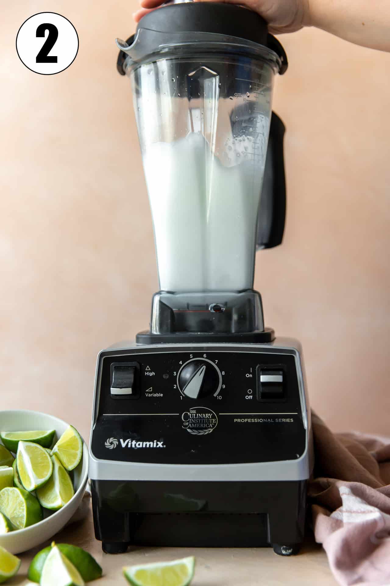 Blender that is mixing up a frozen lime margarita.
