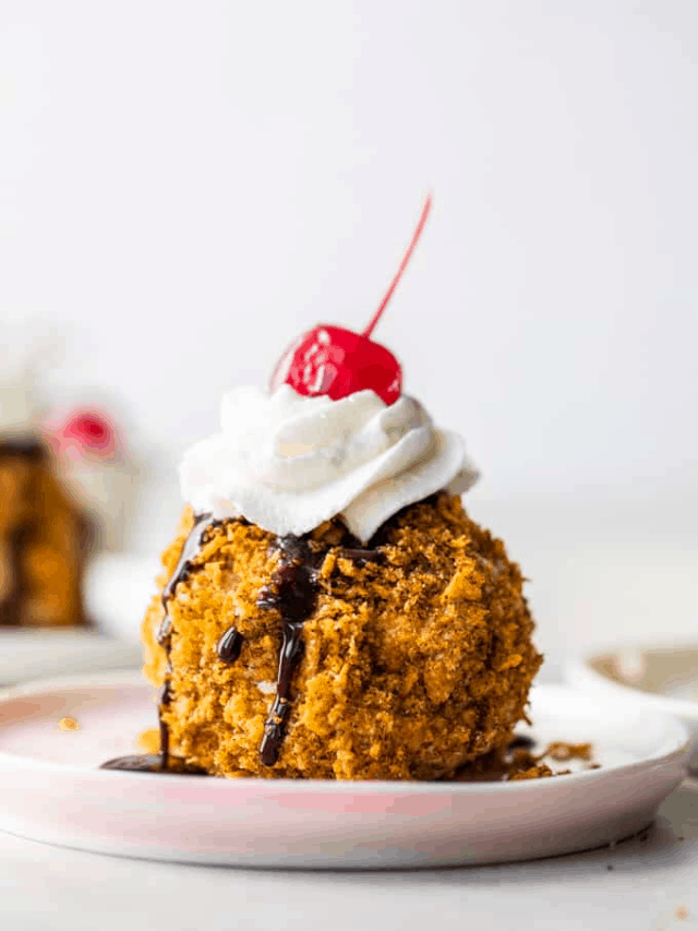 Fried Ice cream served on a plate, topped with whipped Cream and cherries