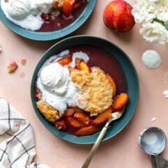 Bowls of fresh homemade peach cobbler that are served with vanilla ice cream.