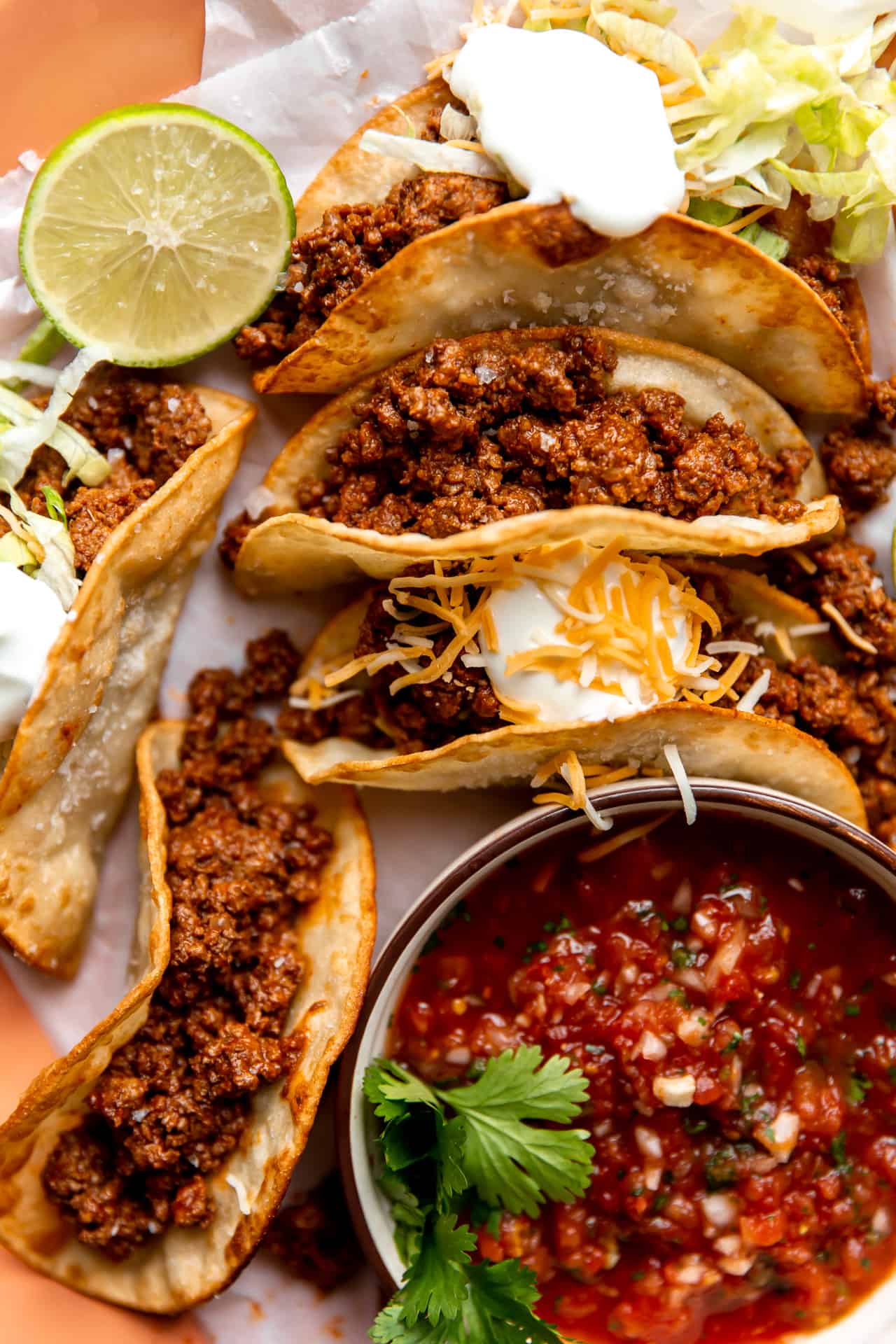 Homemade ground beef taco meat loaded into fried corn tortillas.