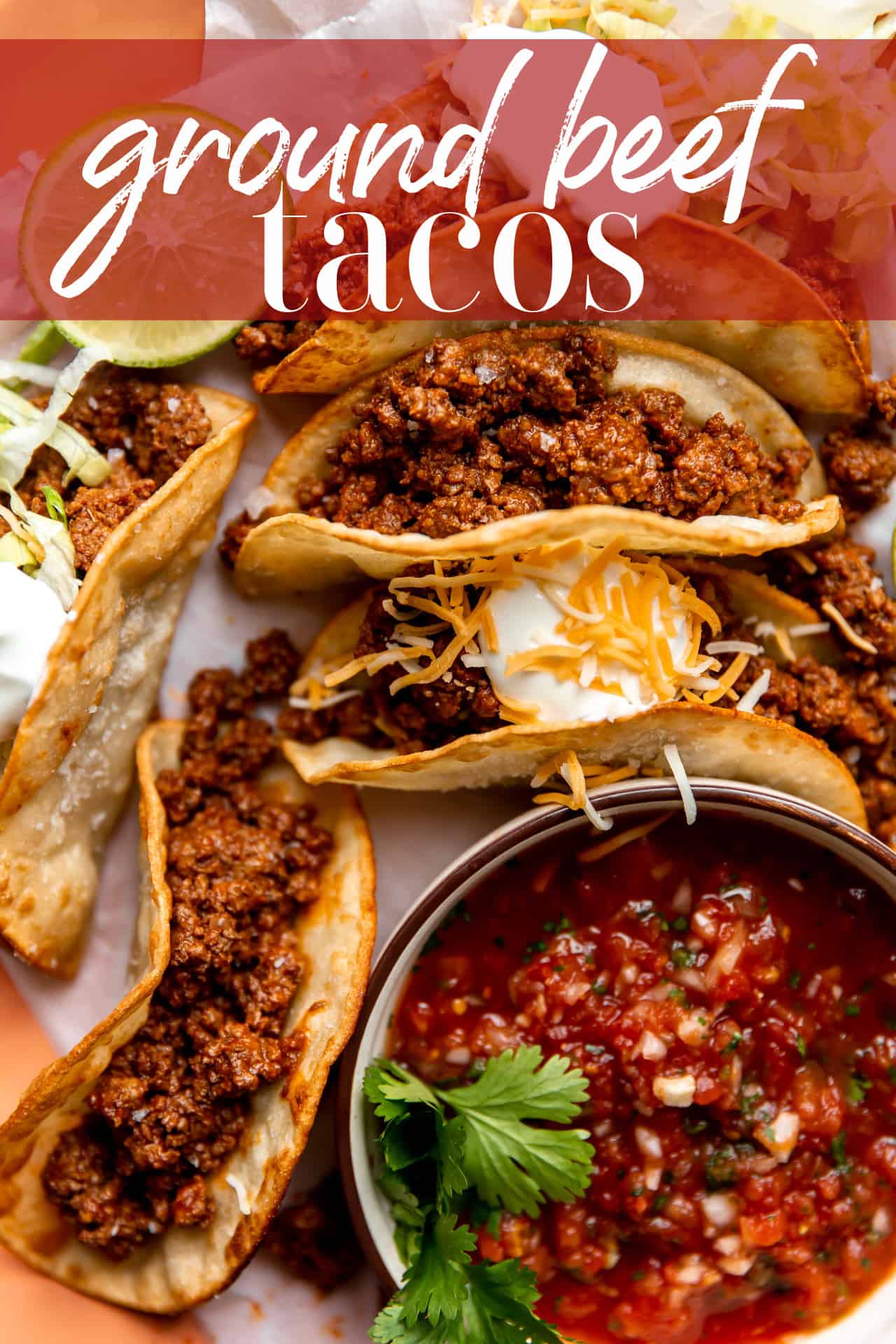 Ground beef tacos on a plate served with a bowl of salsa.
