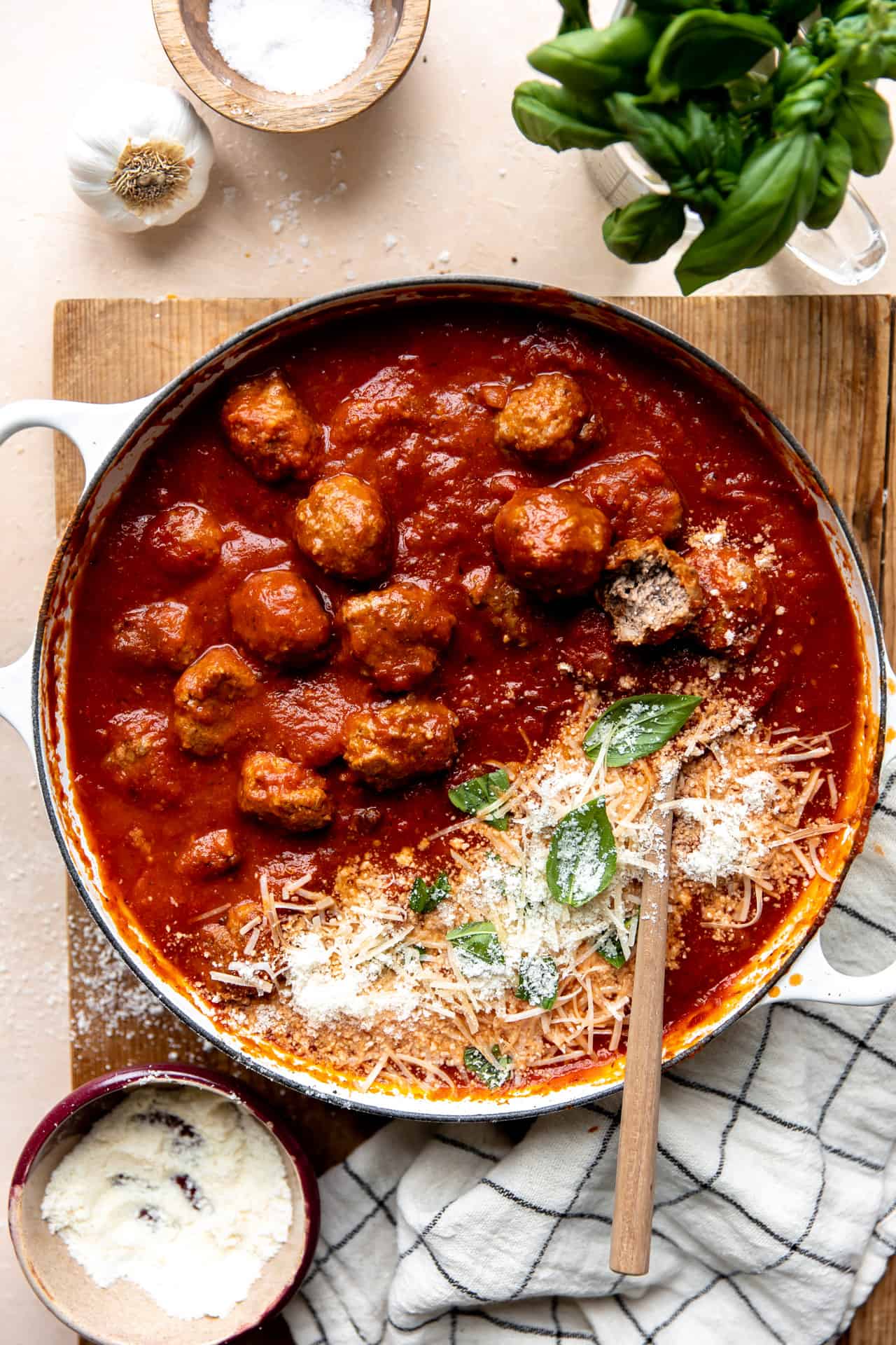 Overhead view of a skillet filled with cooked meatballs in sauce.