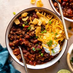 Overhead view of a bowl of chili with toppings.