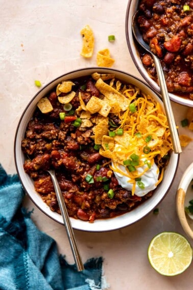 Overhead view of a bowl of chili with toppings.