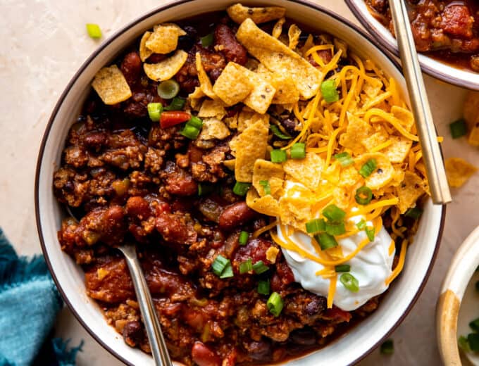 Overhead view of a bowl of chili with toppings.