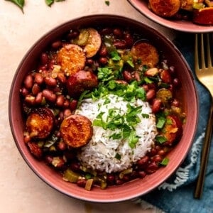 overhead view of a bowl of red beans and rice served with fresh parsley.