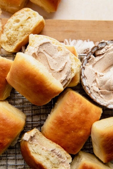 Texas roadhouse rolls split in half and topped with whipped cinnamon honey butter.