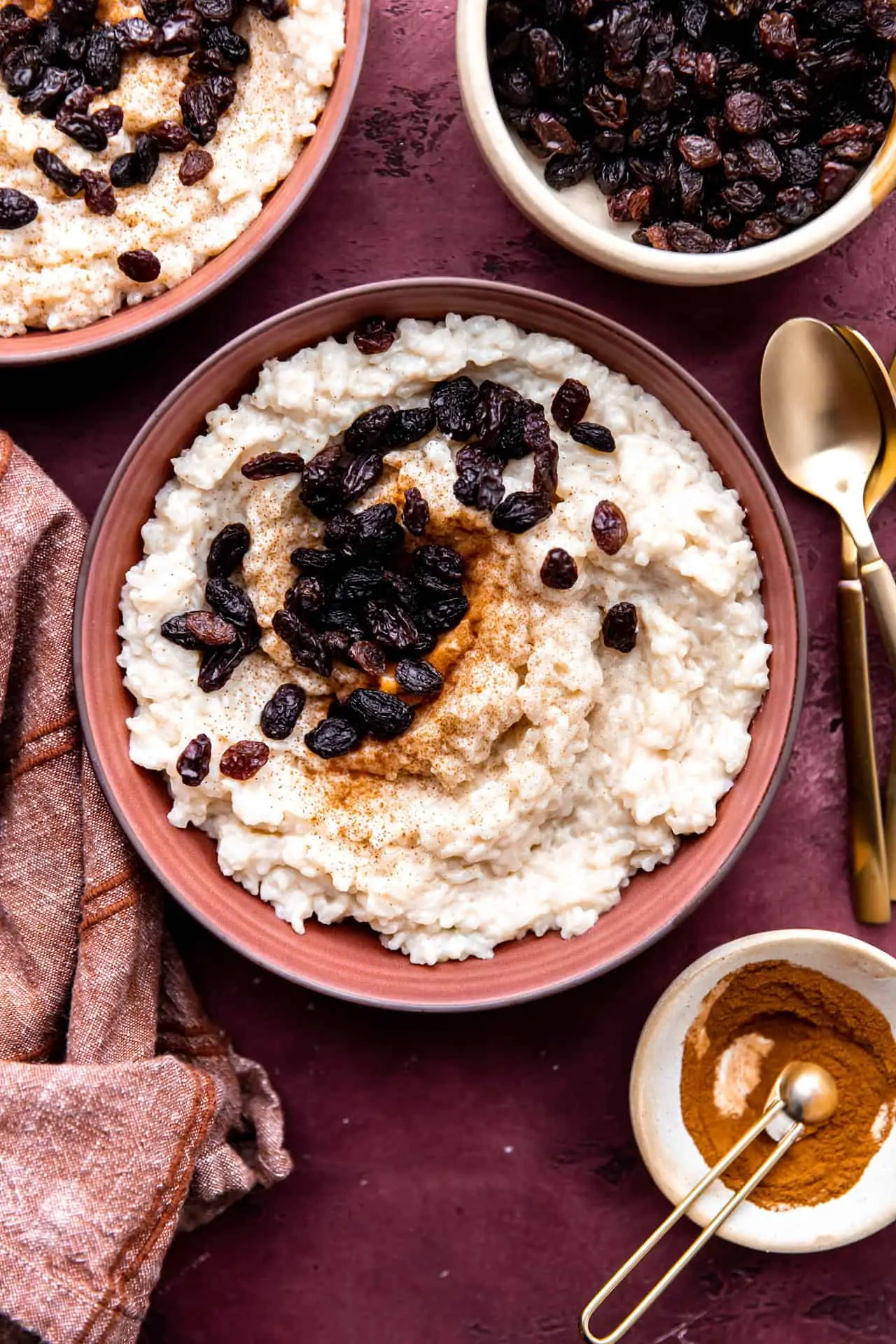 Servings of creamy old fashioned rice pudding topped with raisins.