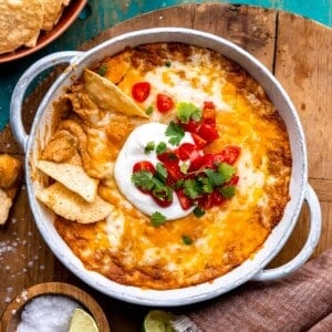 Dish filled with creamy bean dip covered with melted cheese.