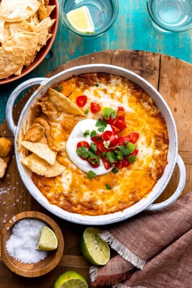 Dish filled with creamy bean dip covered with melted cheese.