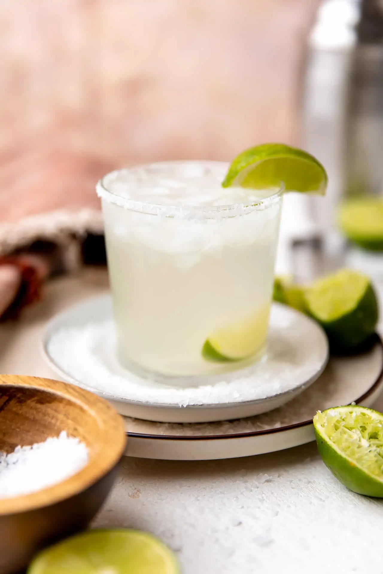 A perfect classic margarita garnished with salt rim and a wedge of lime.