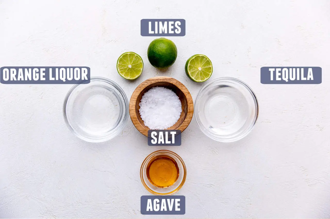 Ingredients needed for making a classic lime margarita laid on the counter.