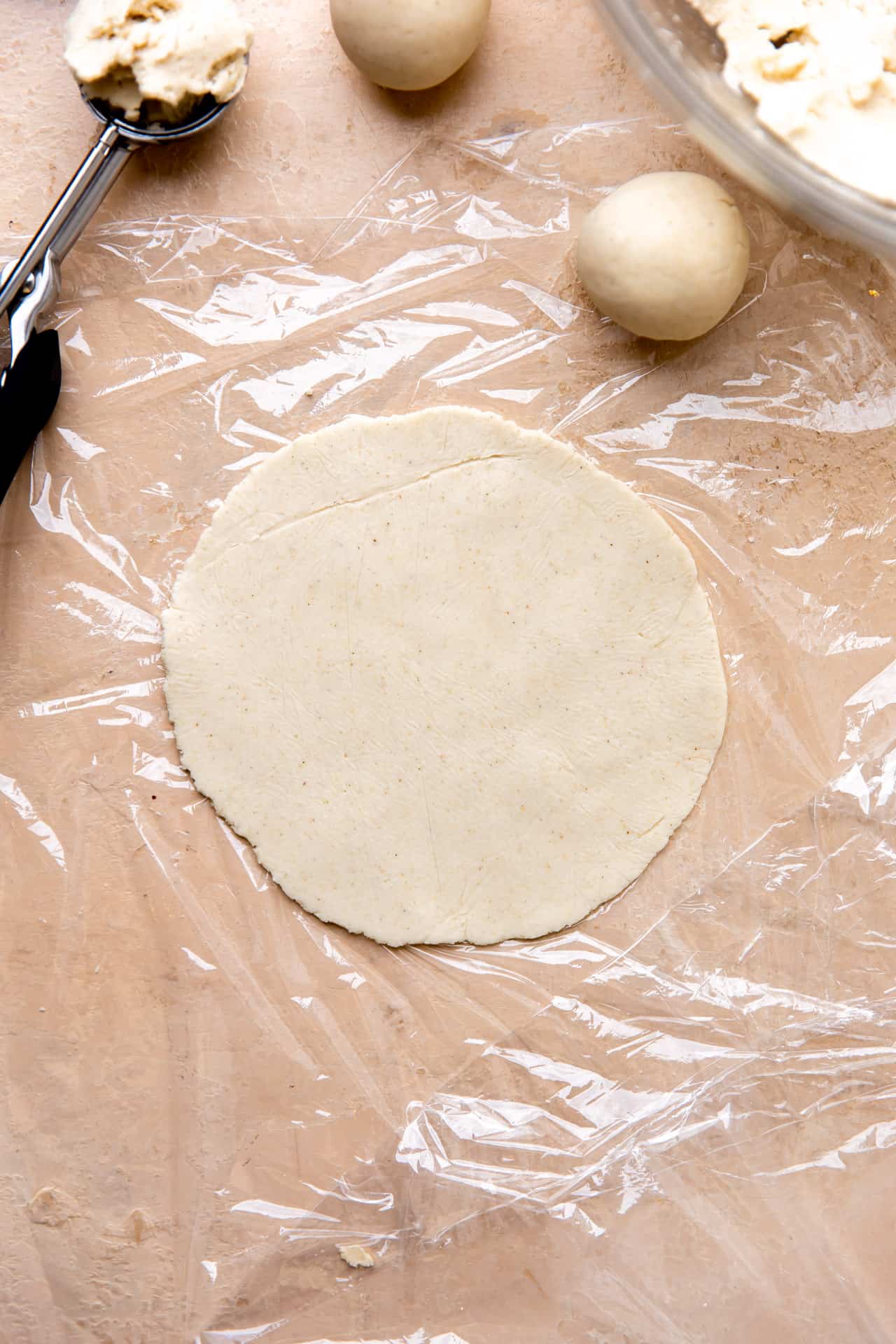 Corn tortilla masa dough pressed into a circle for cooking. 