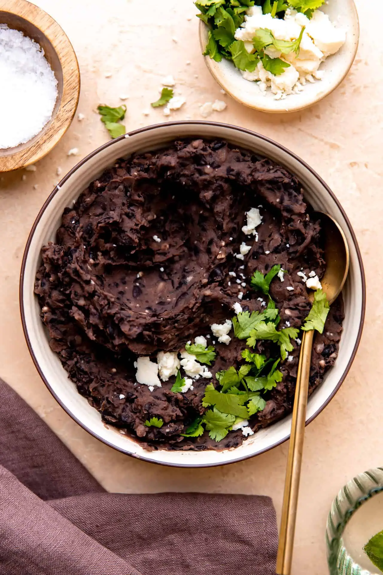 Refried black beans topped with Cotija and cilantro.