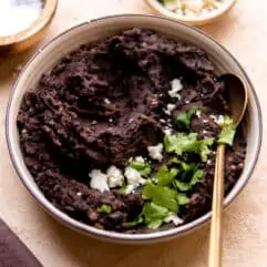 Bowl filled with homemade refried black beans.