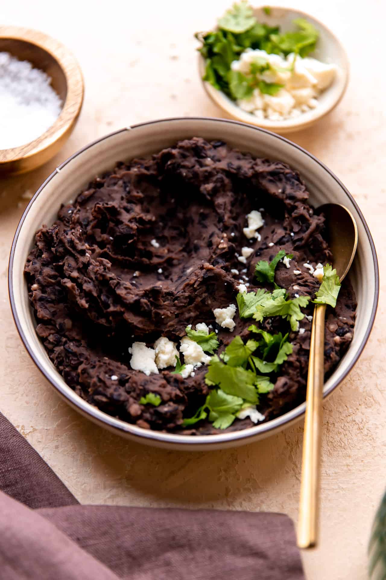 Bowl filled with homemade refried black beans.