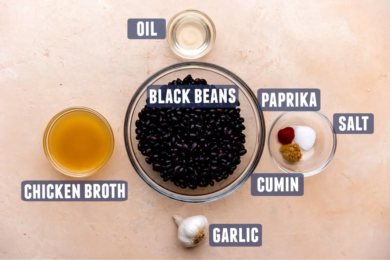 Ingredients needed to make homemade refried black beans laid out on the counter.