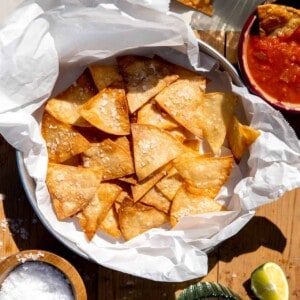 Homemade tortilla chips served with salsa and guacamole.
