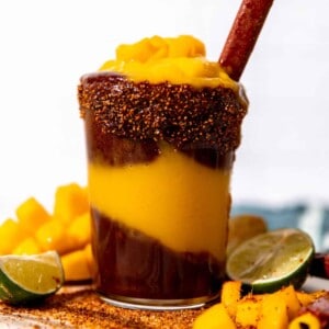 Cup of homemade mangonada served with a tamarindo straw.