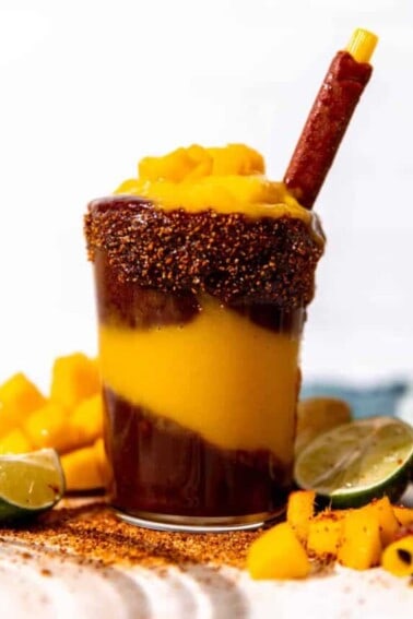 Cup of homemade mangonada served with a tamarindo straw.