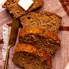 Slices of apple bread laid out with a slab of butter on top.
