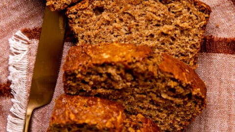 Slices of apple bread laid out with a slab of butter on top.