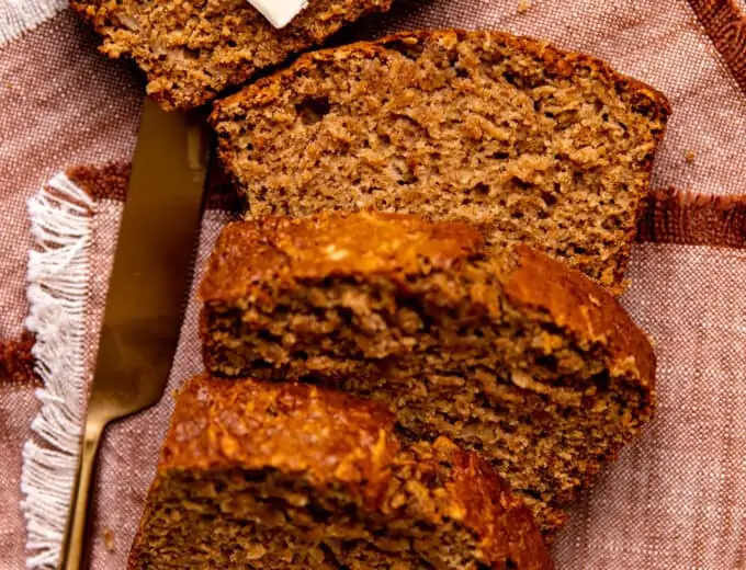 Slices of apple bread laid out with a slab of butter on top.