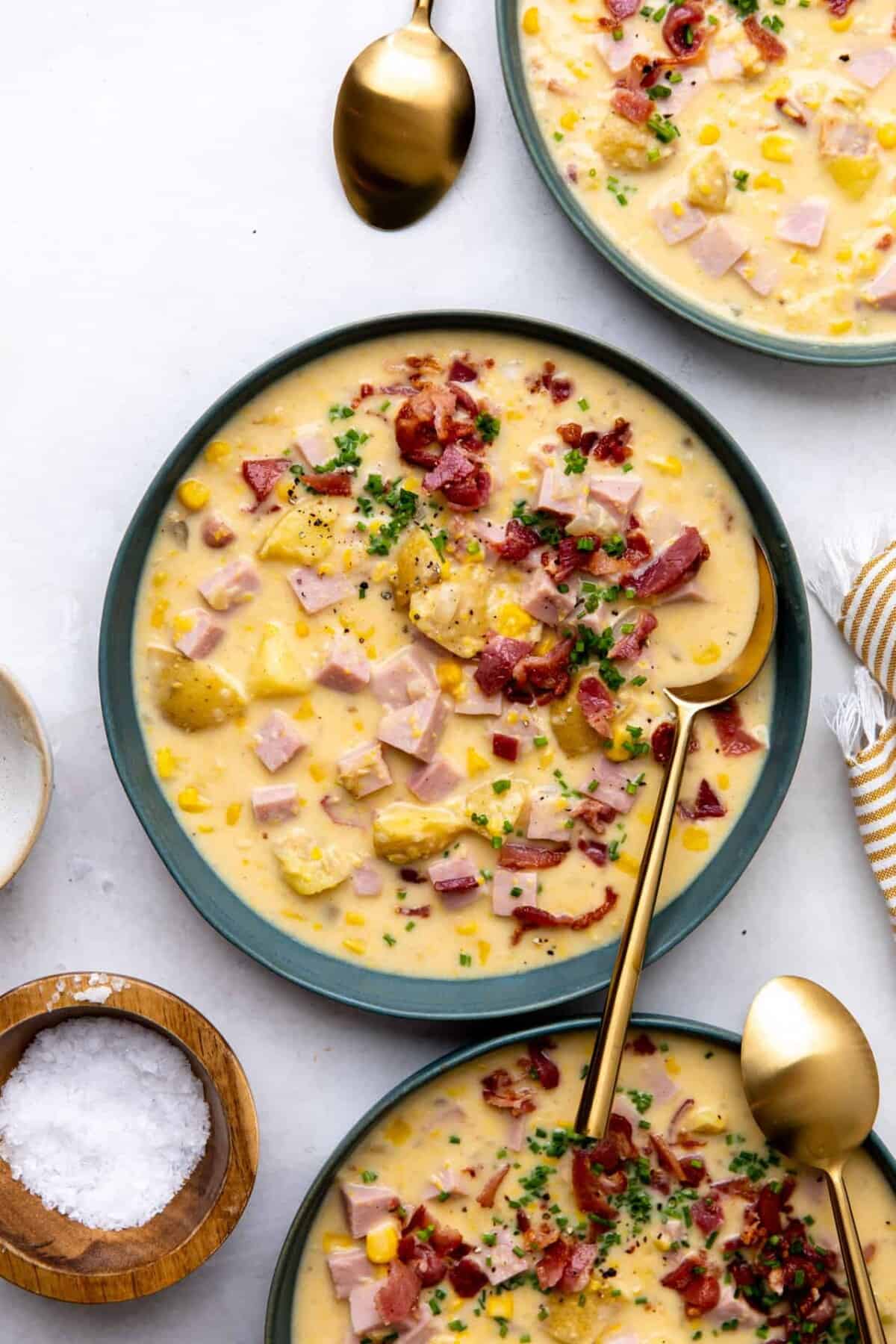 Corn chowder in a bowl with a spoon. 