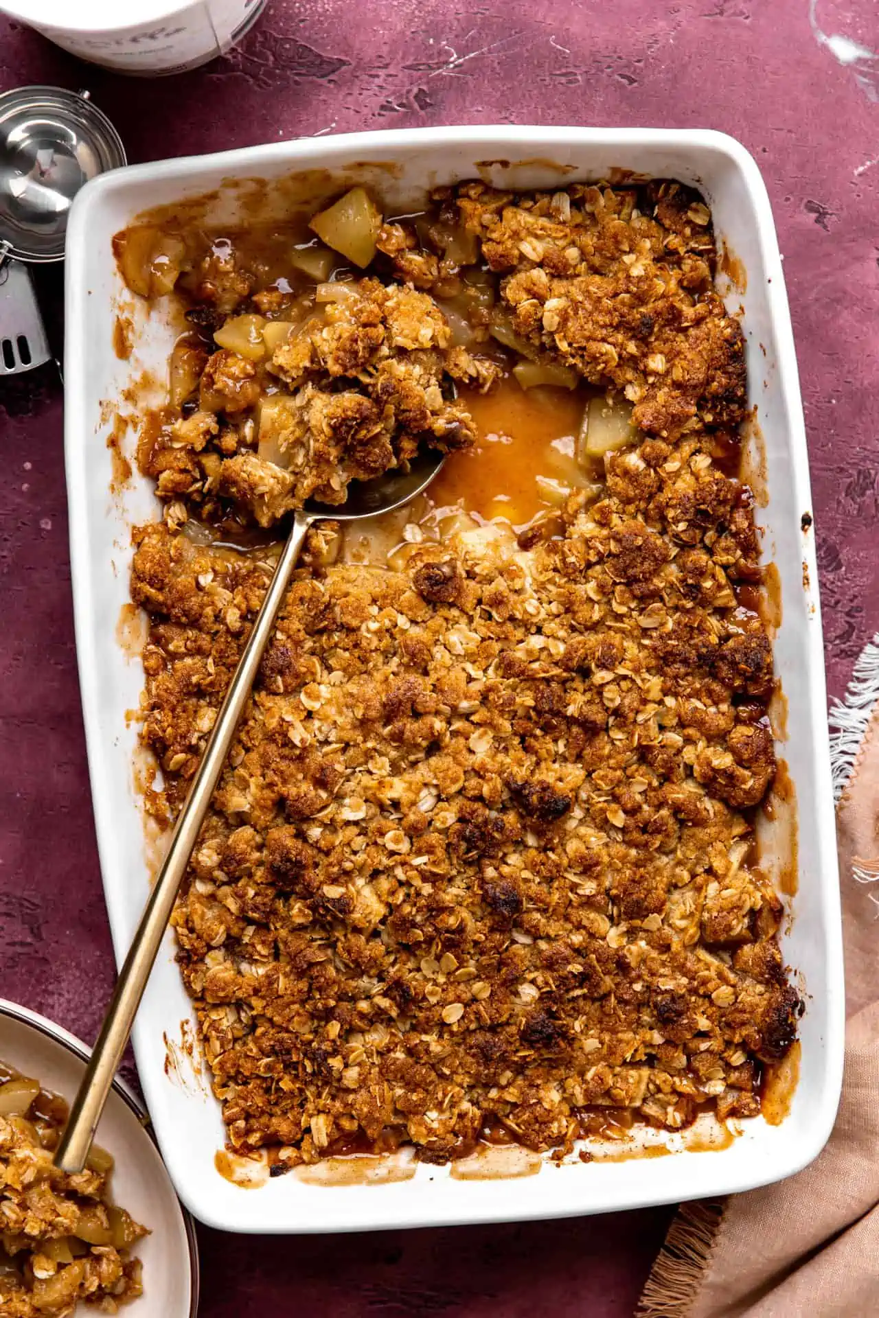 baked apple crisp with brown sugar oat topping in a baking dish.