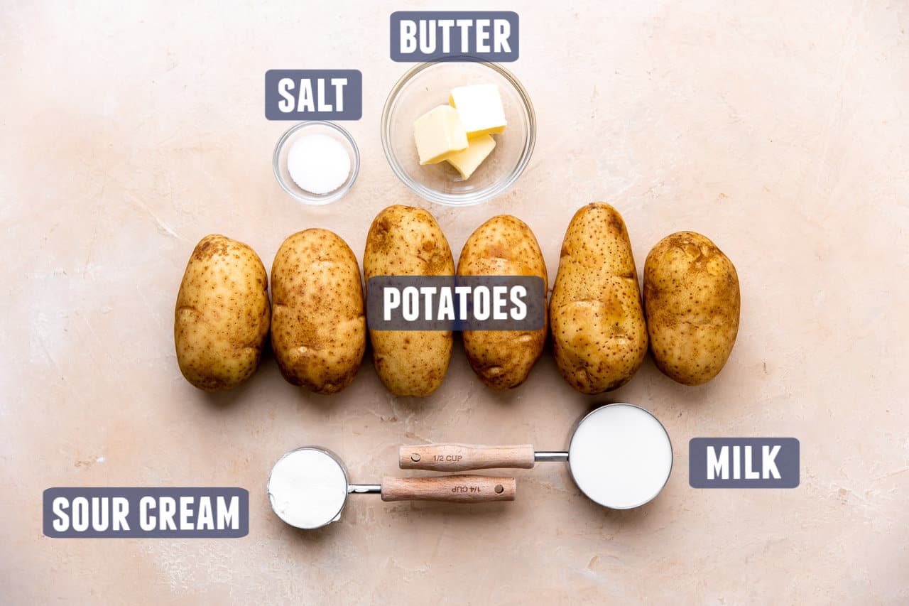 Ingredients needed to make perfectly creamy mashed potatoes laid on the counter. 