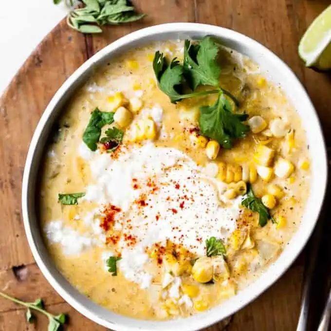 Bowl serving of Mexican Corn Chowder topped with Crema and crumbled queso fresco.