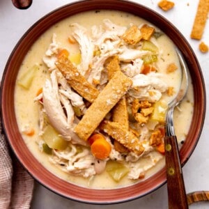 Bowl of pot pie soup served with a spoon.