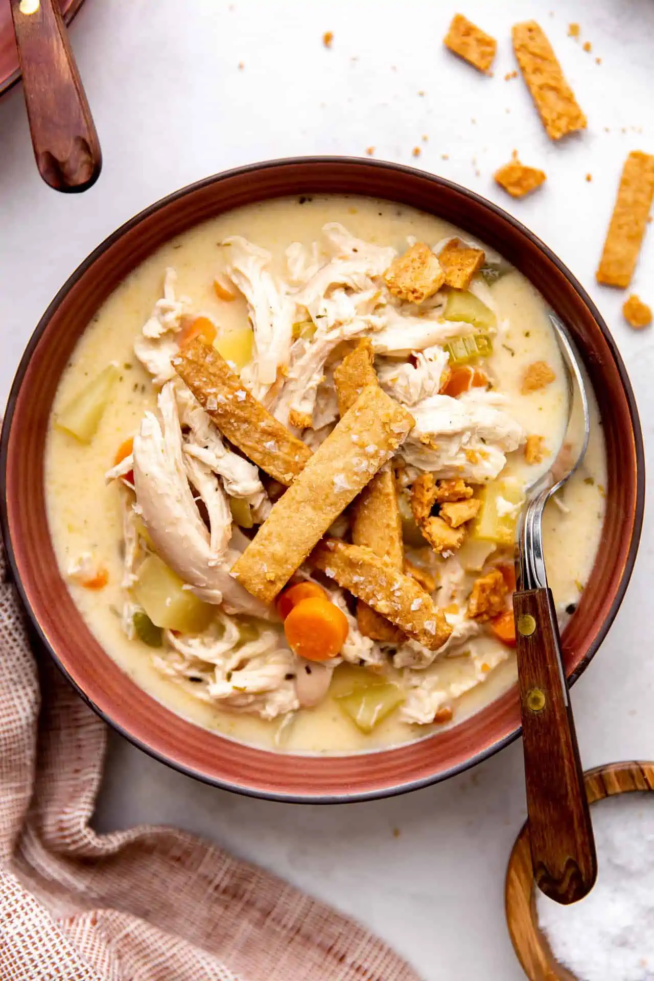 Bowl of pot pie soup served with a spoon.