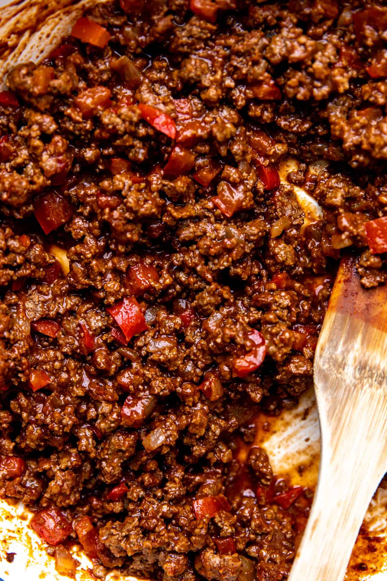 Up close view of cooked homemade sloppy joes in a thick tomato sauce. 