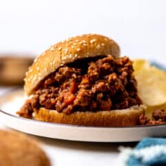 Sloppy Joes with homemade sauce on a hamburger bun served with potato chips.