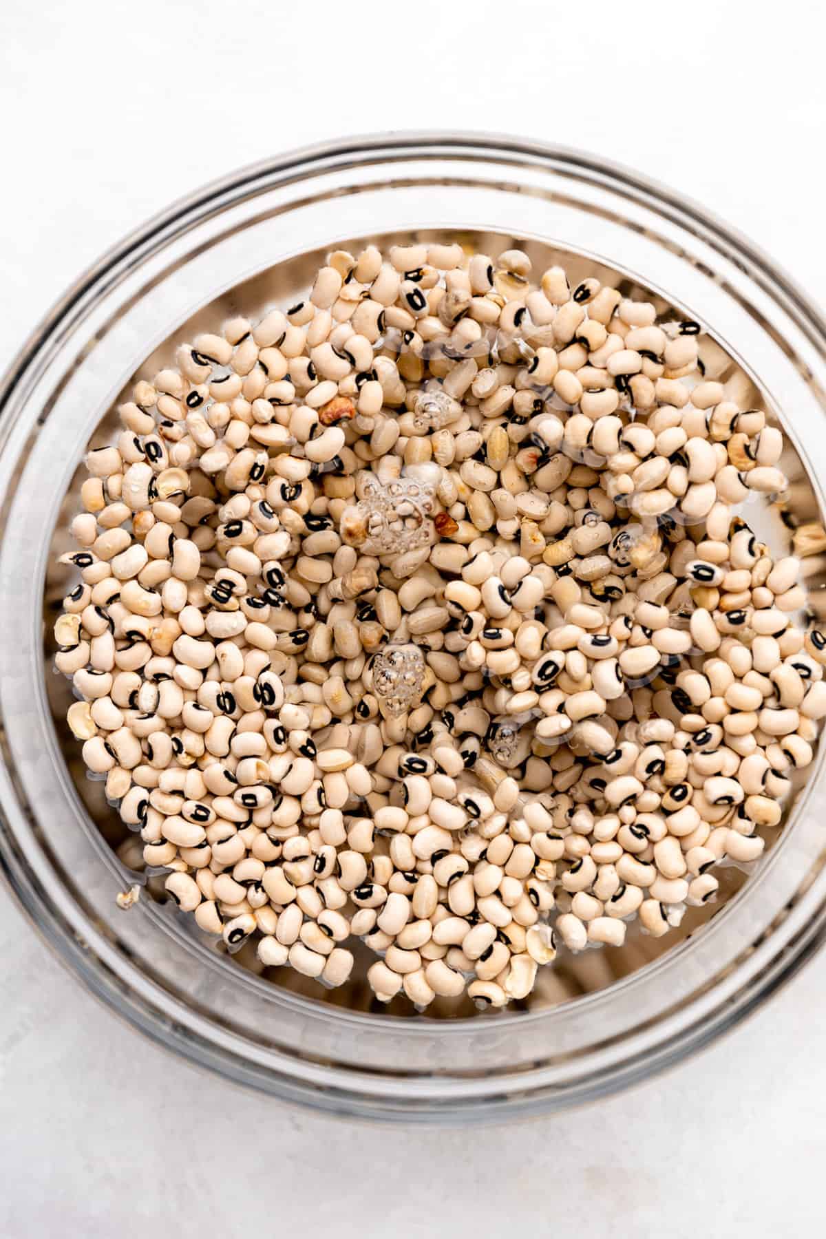 Black eyed peas soaking in a bowl of water. 