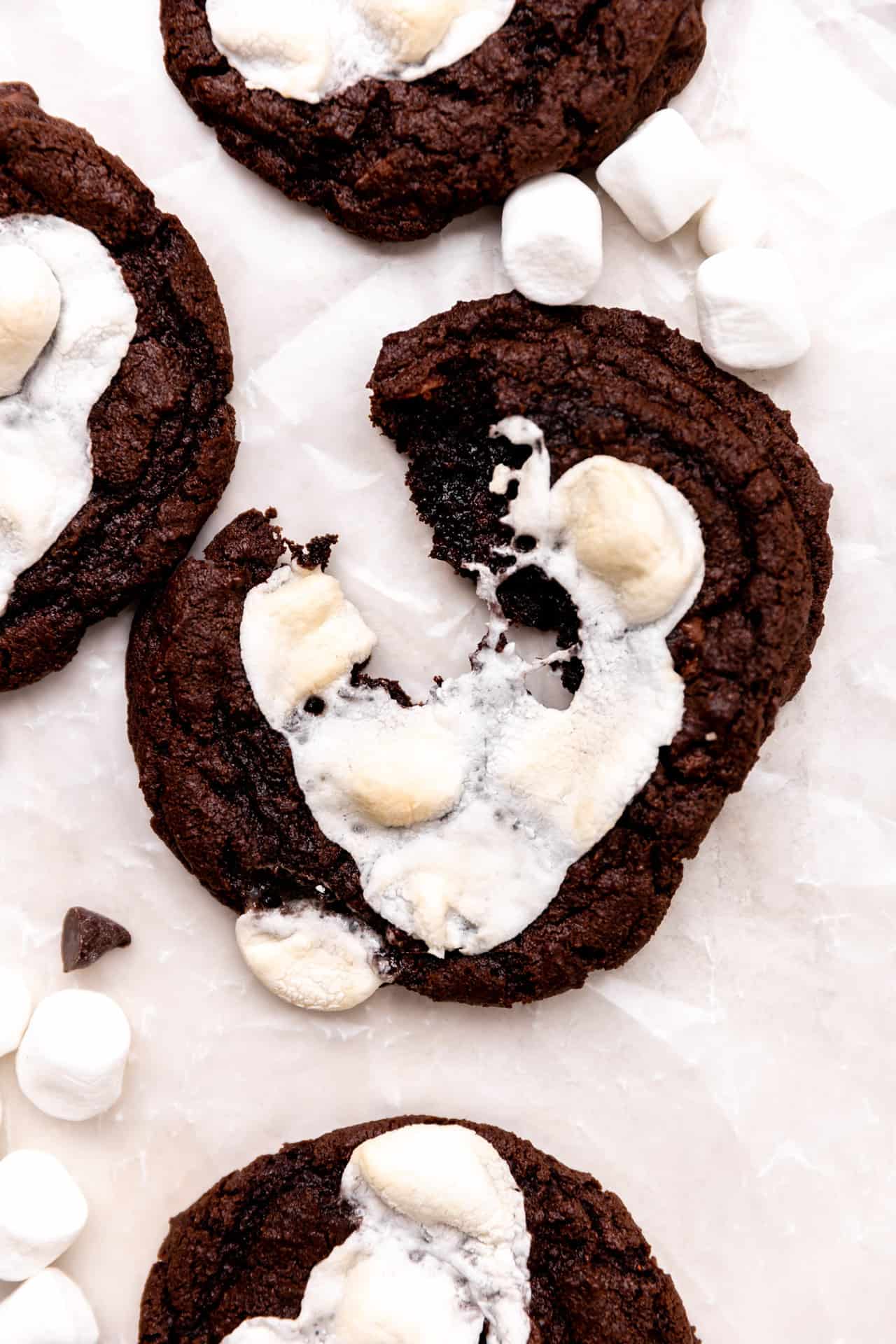 Mexican hot chocolate cookies with marshmallows being split apart.