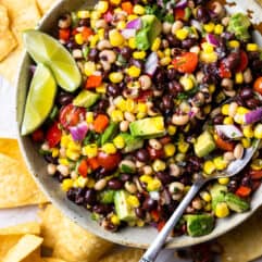 Bowl of Texas Caviar black eyed pea dip served with lime garnish.